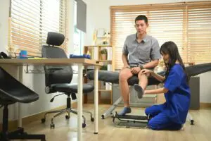 Does Having Surgery Increase Your Workers' Comp Settlement?, Injured patient receiving physical examination at a doctor's office