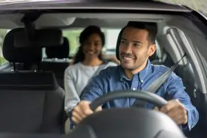 rideshare driver smiling to his passenger