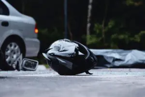 A damaged motorcycle helmet rests on the asphalt in Bensalem, Pennsylvania, after a severe accident. The Bensalem motorcycle accident injury lawyers at Munley Law help riders injured in crashes recover compensation for medical bills, lost wages, and pain and suffering. With a track record of securing millions for clients, our motorcycle injury attorneys fight for the justice you deserve. Contact us at 844-371-5524 for a free case evaluation today.