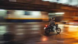Munley Law provides trusted legal support as the best motorcycle accident lawyer in Allentown, PA; call 855-866-5529 for immediate assistance. The image depicts a damaged motorcycle on a Pennsylvania roadway following a severe accident. The motorcycle’s mirrors are shattered, the handlebars bent, and various broken parts lie scattered on the asphalt. The scene clearly emphasizes the severity of motorcycle collisions and the importance of seeking expert legal help promptly.