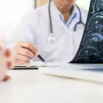 Doctor examining xrays of a brain injury victim