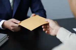 Product liability lawyer - compensation being handed to a client