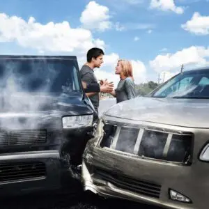 Munley Law car accident lawyer — image of two vehicles with heavy front-end damage after a side-impact crash, with steam rising and scrape marks visible on the asphalt.