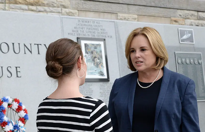 a Stroudsburg distracted driving accident lawyer speaks with a client