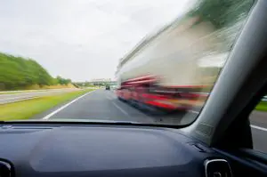car passing large truck