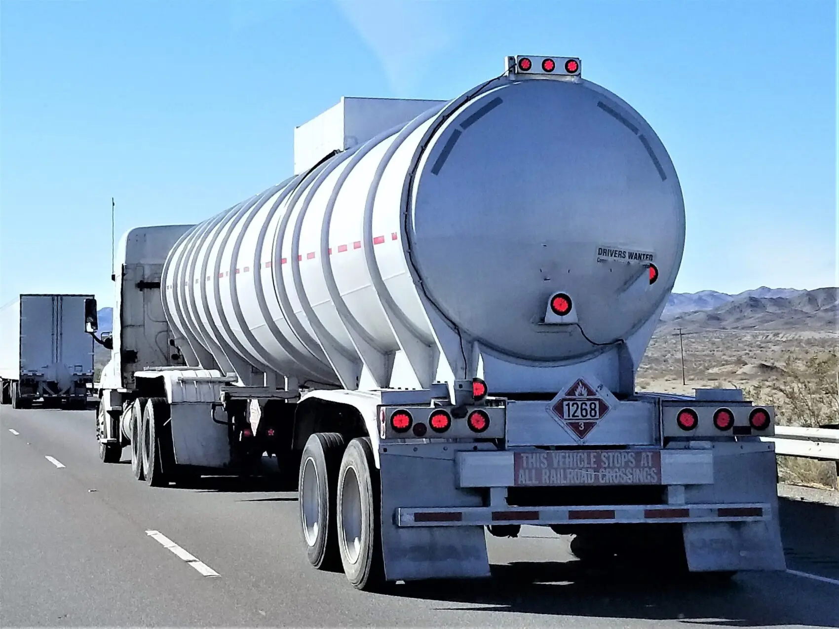 A tanker truck driving down the highway