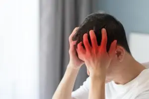 Traumatic brain injury victim holding his head