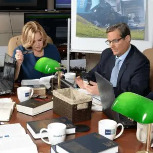 Two motorcycle accident lawyers in Pennsylvania reviewing a case file in a law office, symbolizing Munley Law’s legal advocacy for injured riders statewide.
