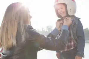 What age can a child ride on the back of a motorcycle