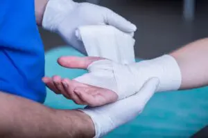 A medical professional in Allentown carefully wraps the wrist of an injured employee with a supportive bandage, highlighting common workplace injuries like sprains and strains. Munley Law’s workers' compensation attorneys help injured workers navigate claims, secure medical care, and recover lost wages. Our team ensures employees understand their rights and receive maximum compensation after workplace accidents. Contact Munley Law at 855-866-5529 for a free consultation on your workers' comp claim in Allentown.