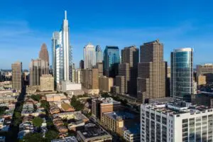 Philadelphia’s skyline glows under a clear sky, with modern high-rises and medical buildings visible. This image provides geographic context for content about a nursing home abuse lawyer serving the Philadelphia area. Call 215-515-7747 for help from Munley Law.
