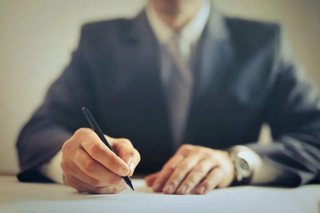 personal injury lawyer writing at his desk