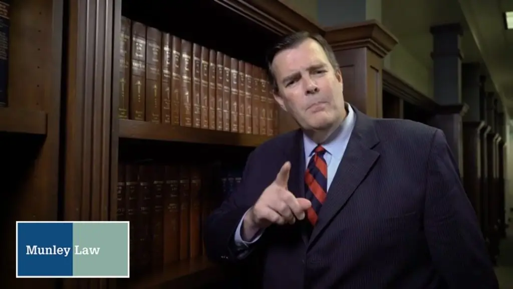 workers' compensation lawyer standing next to bookcase