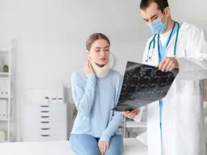 Medical evaluation of a patient wearing a neck brace following a truck accident injury in Scranton. Munley Law, accessible at 855-866-5529, provides legal representation for truck drivers experiencing whiplash, the most common injury from truck accidents. Prompt medical evaluations help document injuries clearly and effectively. Munley Law ensures drivers in Scranton receive fair compensation for whiplash injuries from truck accidents.