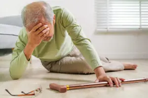 Elderly person holding their head after a slip and fall in carbondale