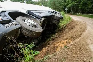 truck lying on its side on a deserted highway