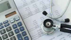 Detailed close-up of medical bills with a calculator and a stethoscope on top, symbolizing healthcare costs after Uber accidents. Munley Law of Scranton, PA, available at 855-866-5529, specializes in securing compensation for medical bills after rideshare incidents. This image emphasizes financial recovery following Uber accident injuries, an area where Munley Law provides expertise. Clients rely on Munley Law’s guidance to navigate compensation processes involving medical expenses after an accident.