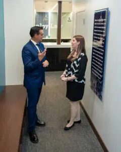 An experienced workers' compensation attorney from Munley Law meets with a client at the firm's Allentown, Pennsylvania office to discuss a workers' compensation death benefits claim. The private consultation illustrates Munley Law's careful and detailed approach in assisting families with denied or contested workers' compensation claims. Munley Law helps Allentown families navigate legal processes, offering clear communication and expert representation. Contact Munley Law at 855-866-5529 to schedule your free consultation for workers' compensation claims.