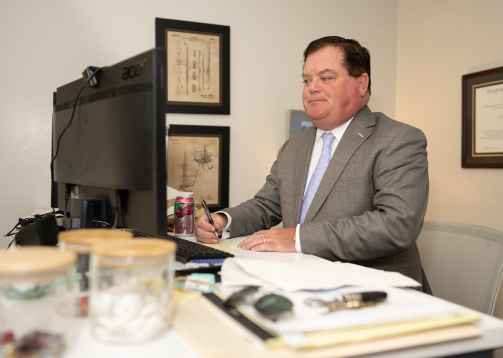 A Pittsburgh product liability lawyer working at his desk