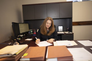 Attorney Melinda Ghiardi working at her desk