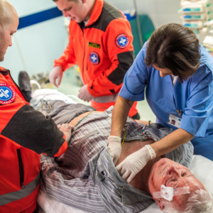 Emergency medical staff attend to an injured man with a head injury
