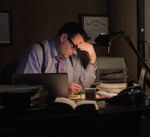 Rideshare attorney working late at night at desk