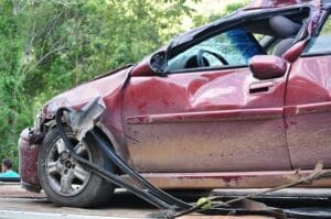 Red car with side impact accident damage