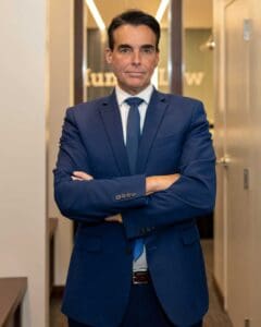 A professional Munley Law brain injury lawyer confidently standing in the law firm's Philadelphia office. Dedicated to advocating for brain injury victims, Munley Law attorneys provide thorough legal guidance. Contact our Philadelphia office at 215-515-7747.