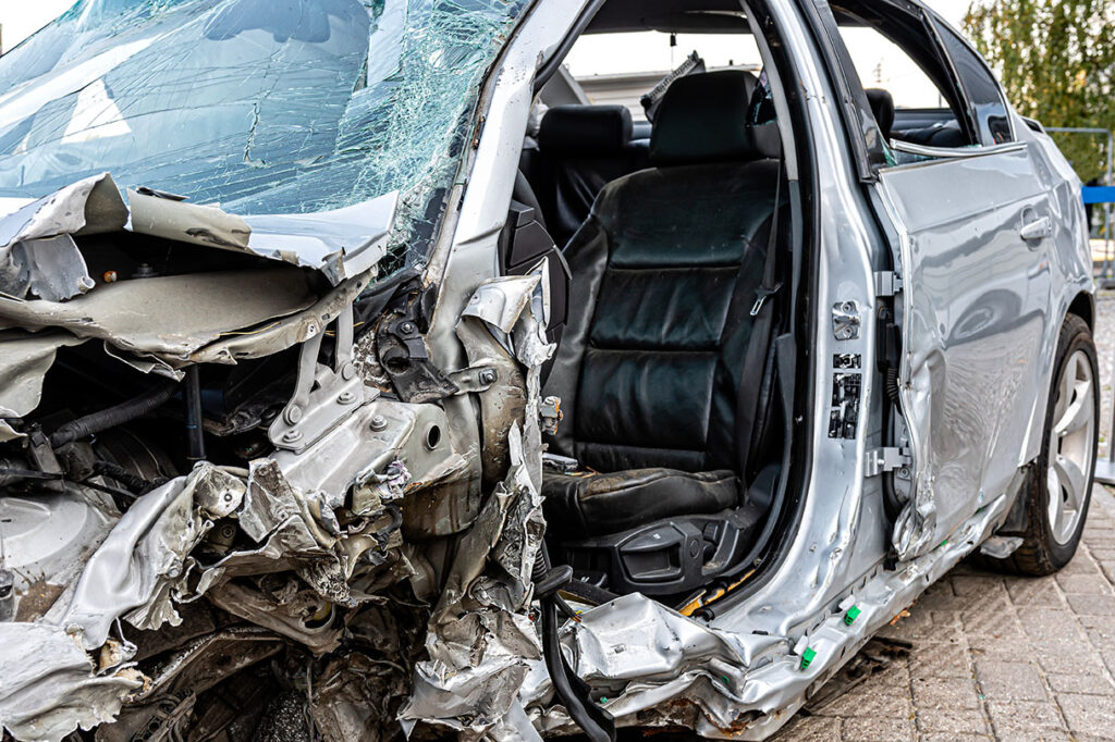 damaged vehicle closeup after a heavy crash, car wreck, insurance concept