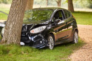 Car crashed into a tree with front end damage