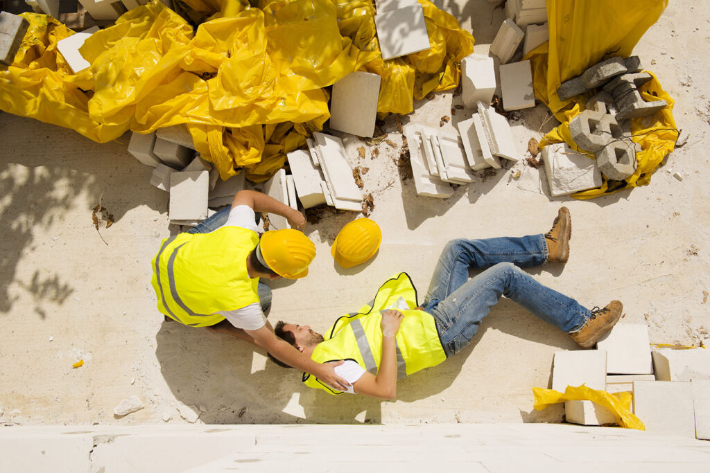 Construction worker helping an injured worker