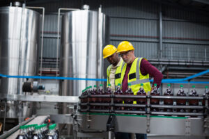 Product liability attorney - workers monitoring soda bottling