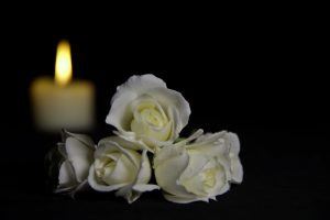 Flowers and candle in dark room
