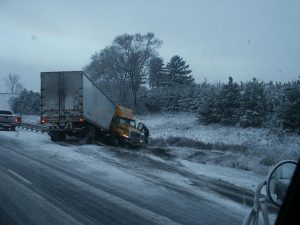 jackknifed truck on side of the road
