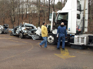 Truck Accident Lawyer Dan Munley examines the wreckage of a truck accident