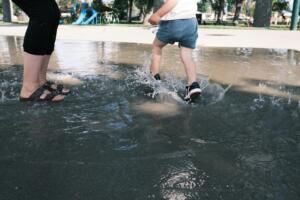 Child and parent on a splash pad