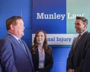 Three Munley Law attorneys under the company sign