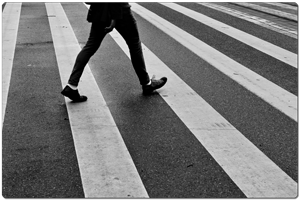 A pedestrian walking across the street in Philadelphia