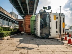 Scene of a rollover accident involving a commercial truck in Scranton, clearly displaying vehicle damage and debris. Munley Law, at844-686-5397, supports Scranton truck drivers injured in such accidents. Truck rollover incidents frequently lead to whiplash, the primary injury truck drivers experience. Munley Law provides dedicated legal representation for drivers suffering injuries following rollover accidents.